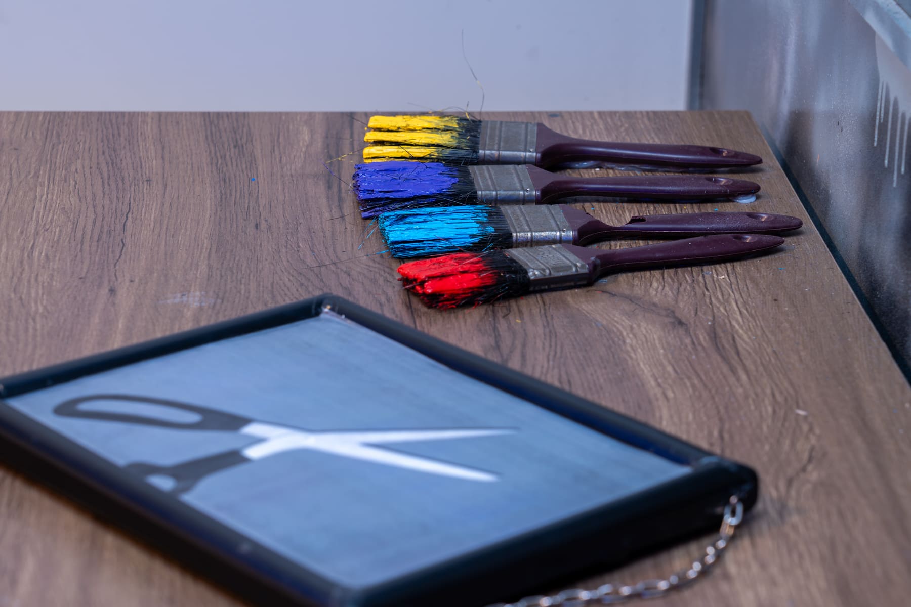 Bright paintbrushes and art supplies arranged inside Lost Without Hue.