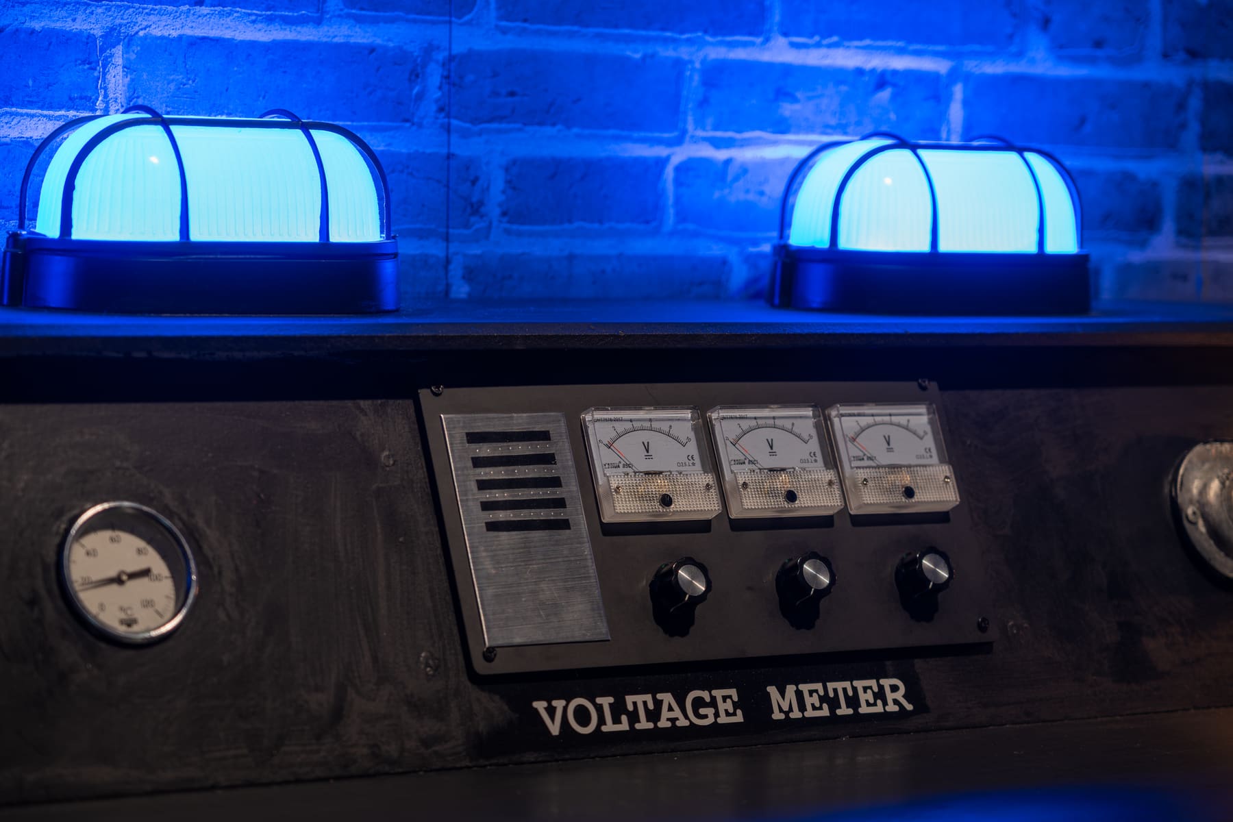 Blue light glowing across Tesla-inspired meters and electrical apparatus inside Memories of Nikola.