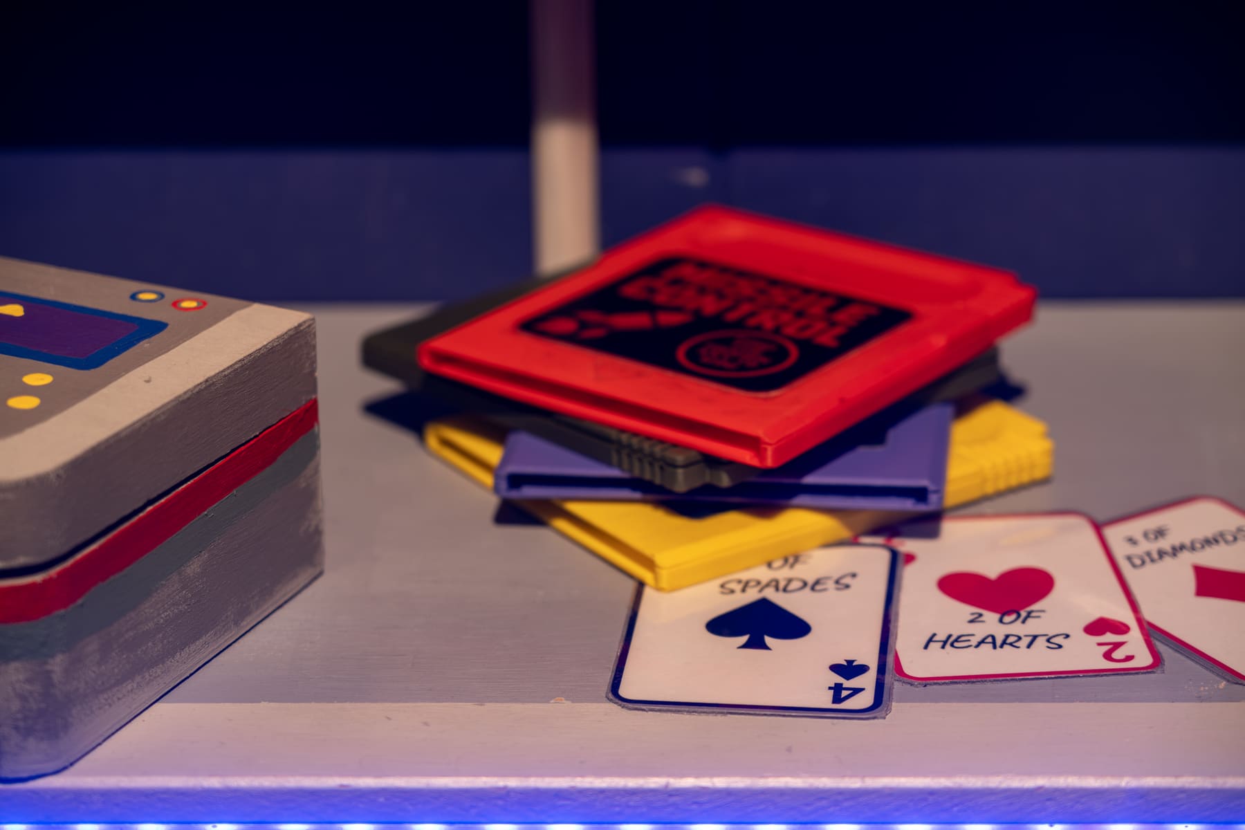 Oversized playing cards and colourful game pieces inside The Arcade.